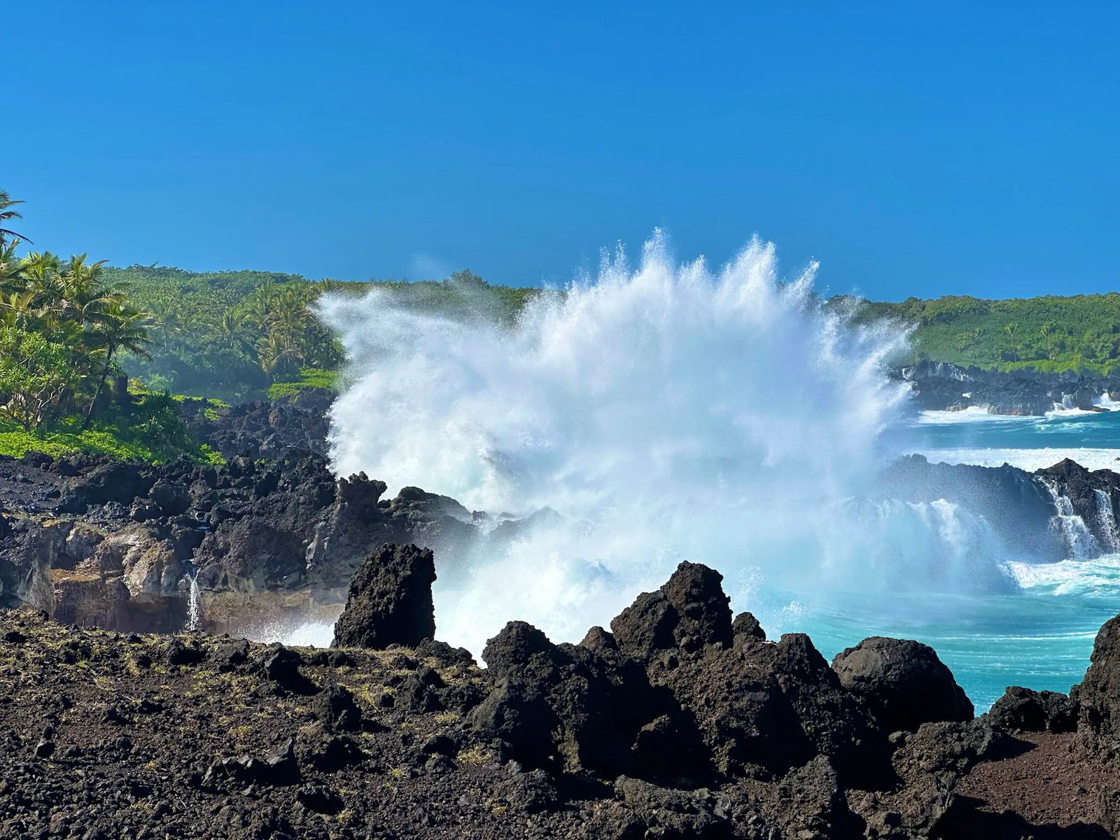 Surf exploding against the East Maui lava cliffs